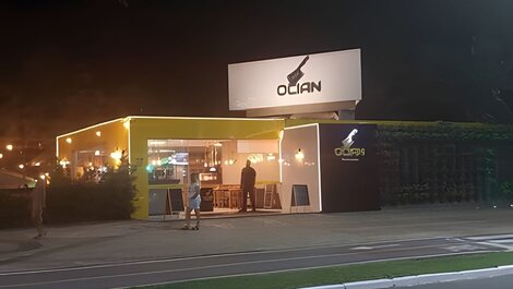 In front of the Ocian kiosk on the beach, standing on the sand